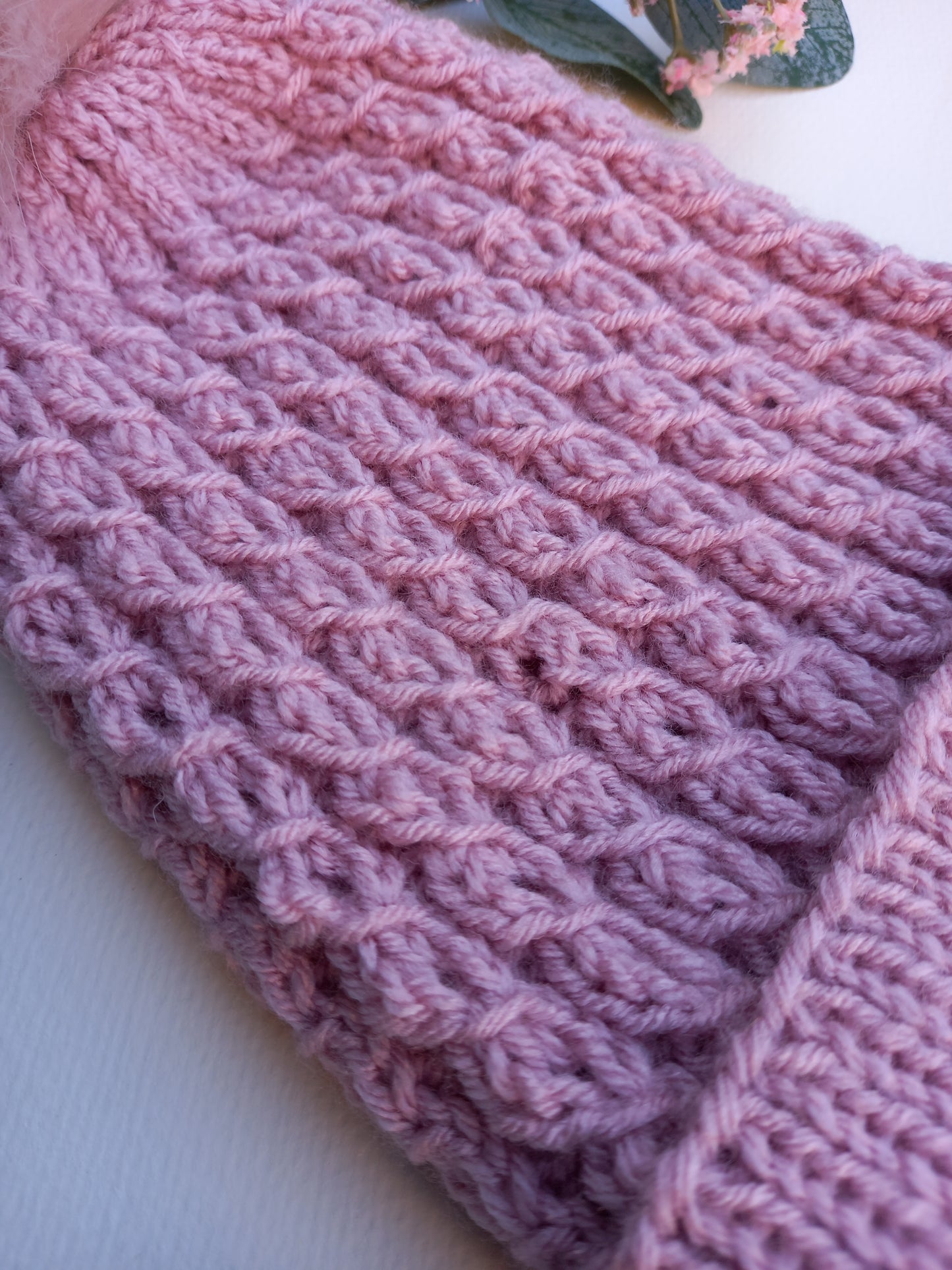 A close up of the faux cable pattern of the hat. 